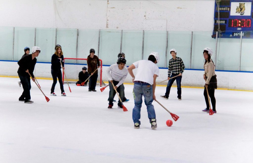 Group of friends playing broom ball