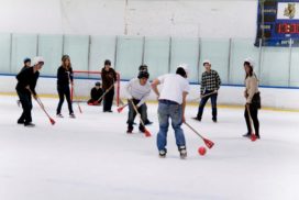 Group of friends playing broom ball